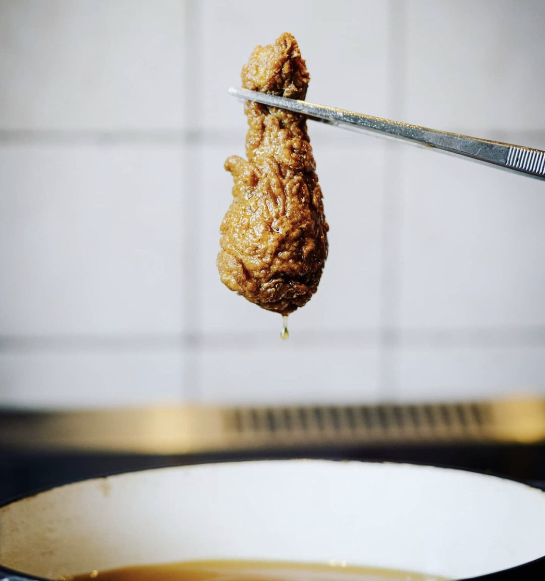 Fried chicken lifted from the fryer during recipe testing