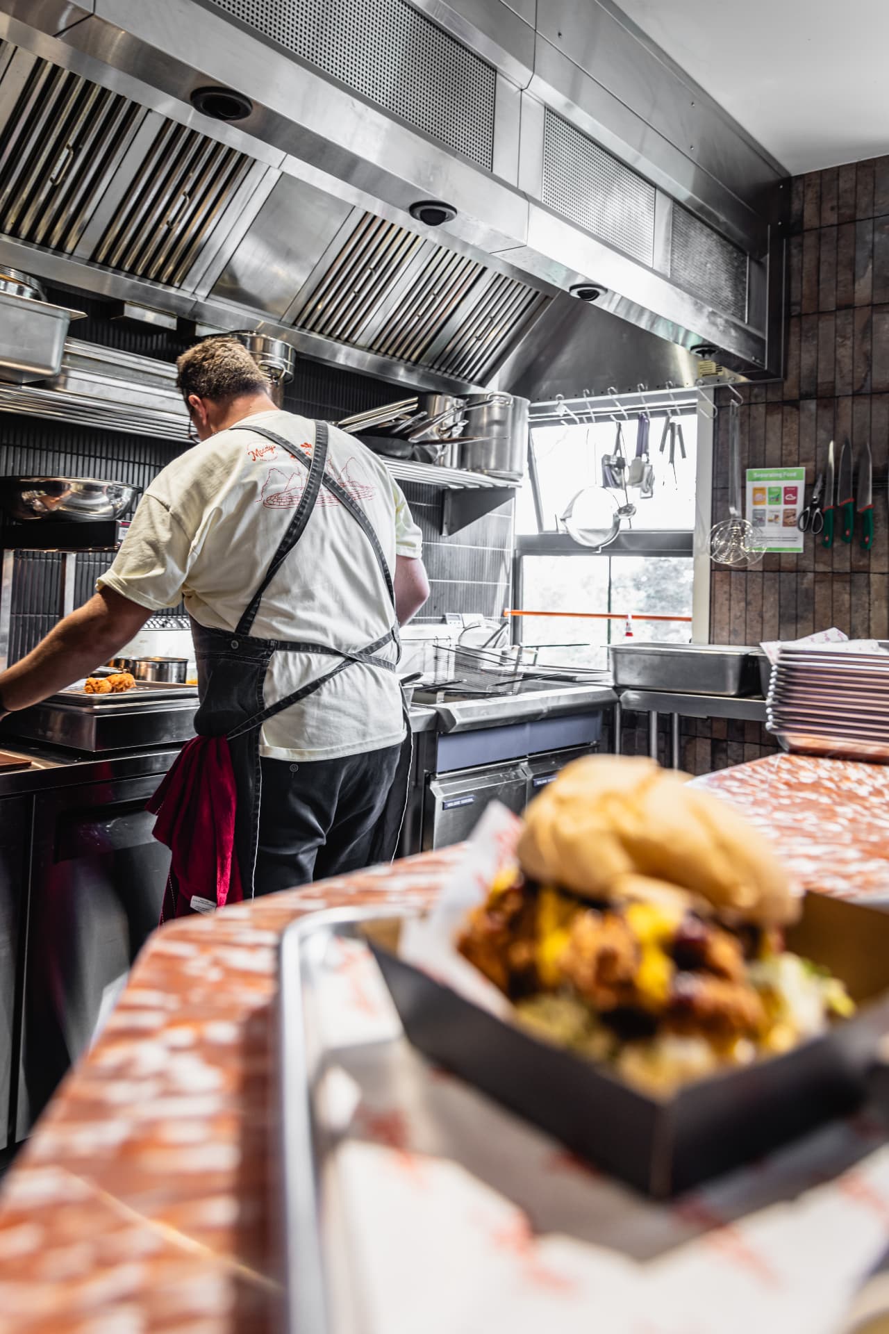 Chef working the line in a delivery-first kitchen